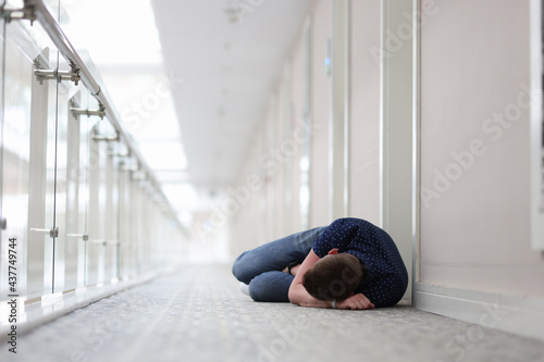 Young man sleeps under door of hotel complex © H_Ko