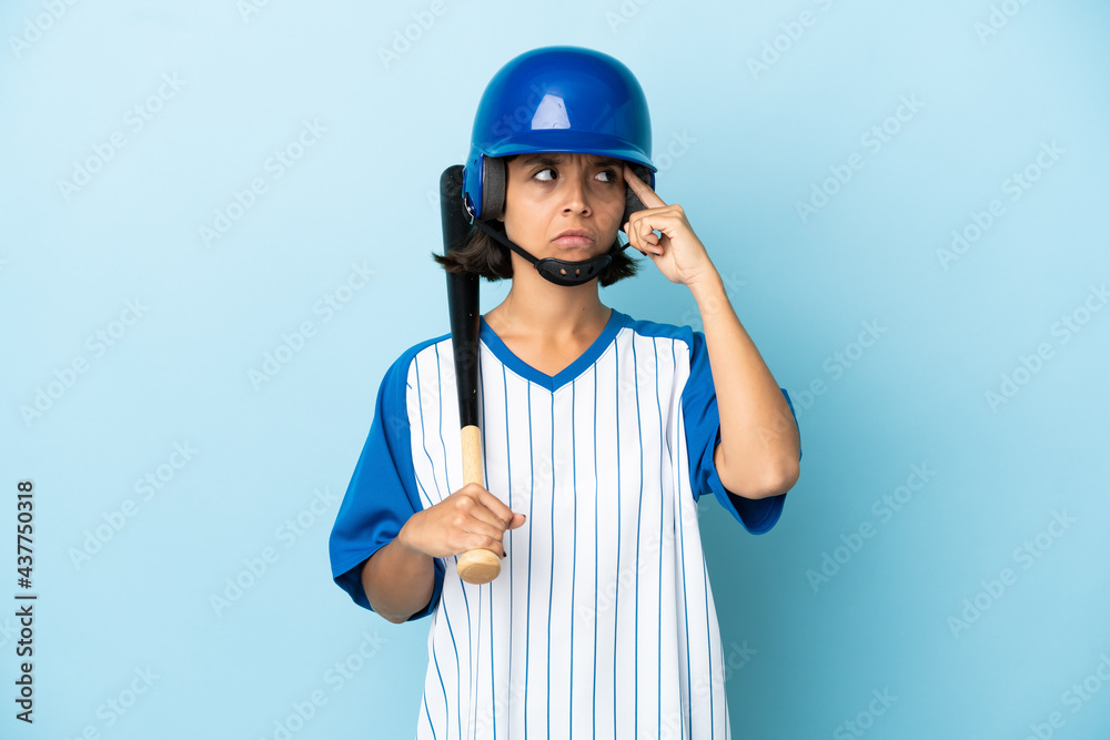 Baseball mixed race player woman with helmet and bat isolated on blue background having doubts and thinking Baseball mixed race player woman with helmet and bat isolated on blue background having doubts and thinking
