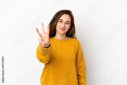 Young caucasian woman isolated on white background happy and counting three with fingers