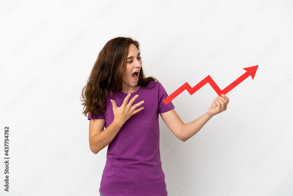 Young caucasian woman isolated on white background holding a catching a rising arrow with surprised expression Young caucasian woman isolated on white background holding a catching a rising arrow with surprised expression
