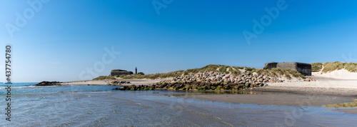 old bunkers on the beaches at Skagen in north Denmark with the lighthouse in the background