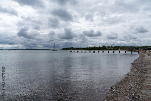 sailboat leaves the harbor and marina of Sonderborg and sails out into the Alssund