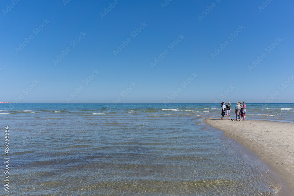 five women standing at the northern tip of Denmark where the Baltic Sea and North Sea meet at Skagen Reef