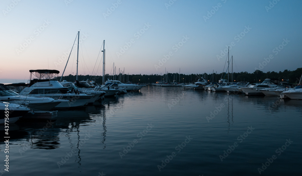 A harbor/marina filled with sailboats during a blue/orange sunset in Port Elgin, Ontario, Canada.