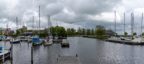 many boats moored in the marina at Sloten in the Netherlands photo