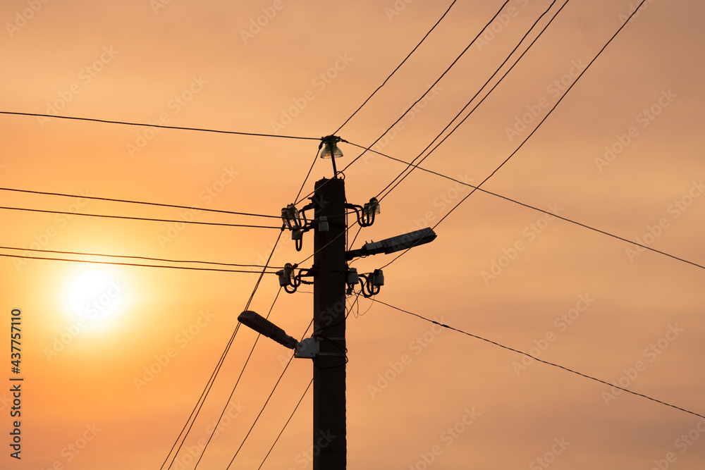 Concrete tower of power lines with lanterns against the sky with smog Concrete tower of power lines with lanterns against the sky with smog