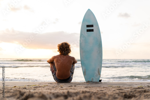 Photography Young caucasian man get up early to  doing surf at sunrise
