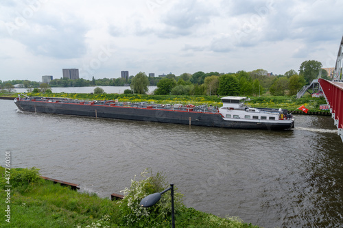 large riverboat barge tranporting goods along the wide canals of Amsterdam photo