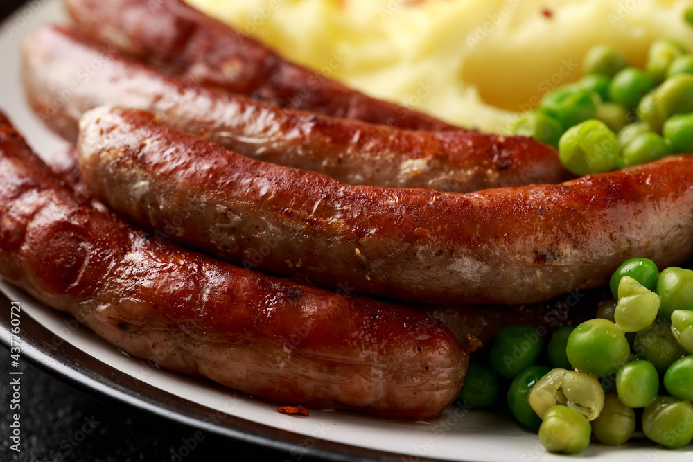 Pork Chipolata sausages with home cooked mashed potato and green peas