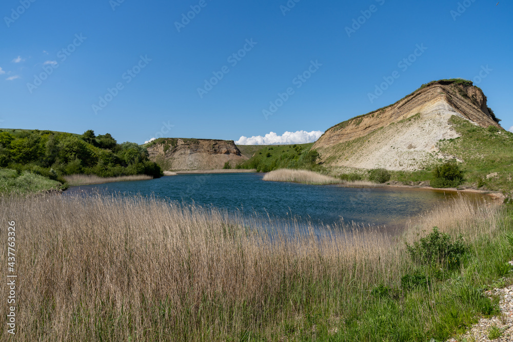 view of cliffs and picturesque lagoon under a blue sky