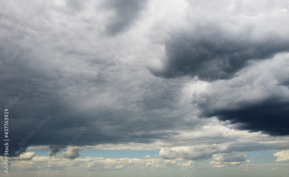 Beautiful contrasting large clouds in blue sky for background