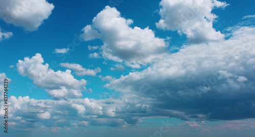 Beautiful contrasting large clouds in blue sky for background