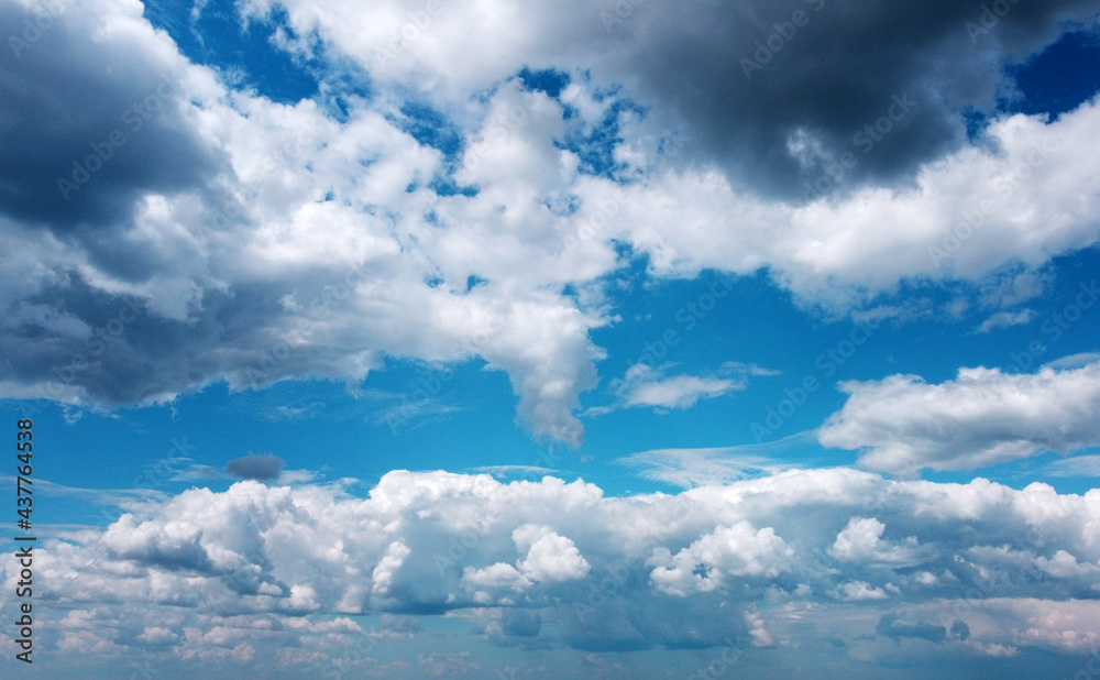 Beautiful contrasting large clouds in blue sky for background