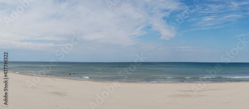 panorama view of amazing white sand beach and calm ocean under an expressive sky photo