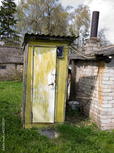 Old wooden toilet in a rustic manor.