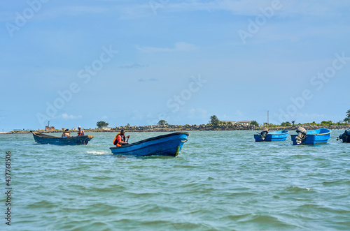 fisherman sails on a motor boat in the bay photo