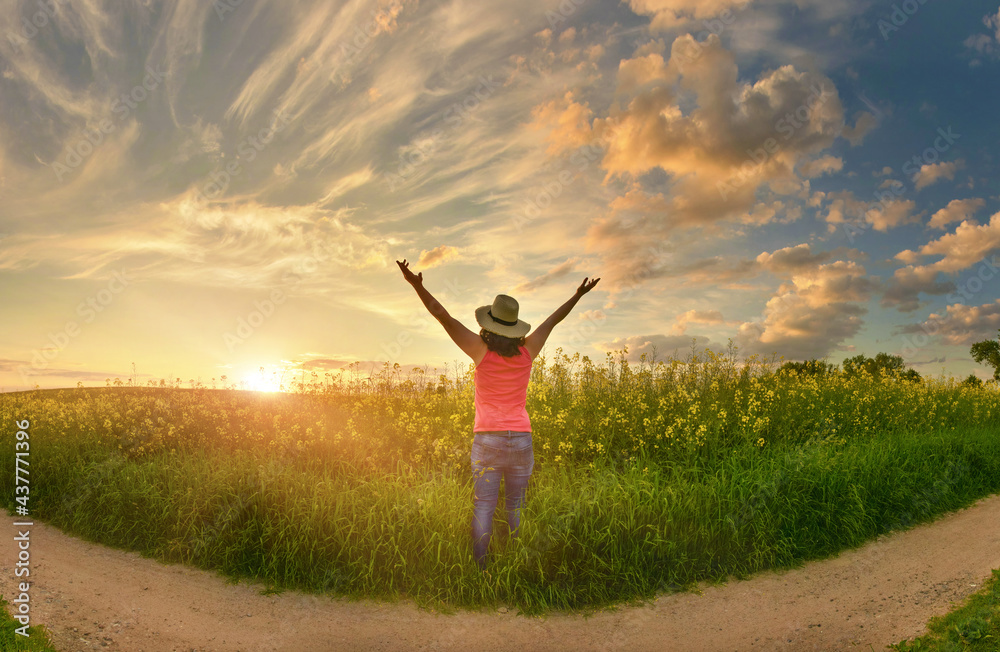 Happy woman enjoys beautiful sunset on flower field Happy woman enjoys beautiful sunset on flower field