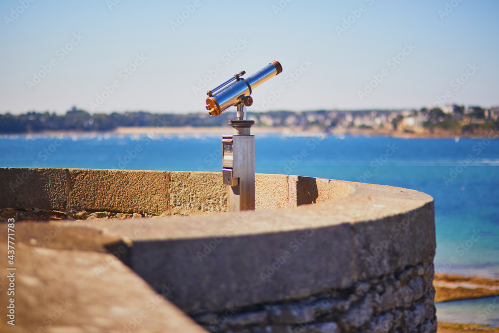Touristic telescope on the fortress wall surrounding Saint-Malo Intra-Muros in Saint-Malo, France