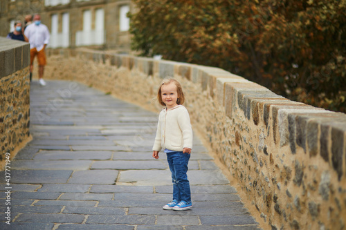 Toddler girl walking on city wall in Saint-Malo, Brittany, France © Ekaterina Pokrovsky