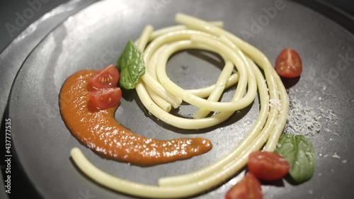 Gimbal shot of fine italian noodles pasta maccheroncini with tomatos