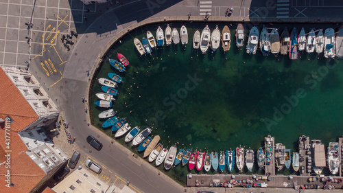 Aerial view of boats moored in the tartini square in piran, different boats resting on the edge of Piran marina. photo