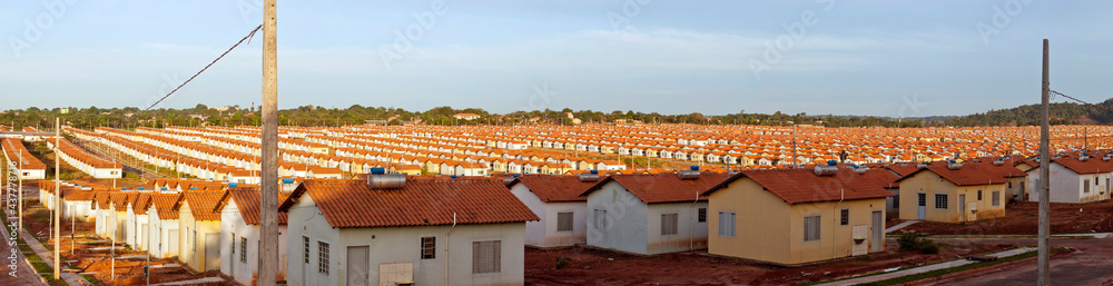 Panorama of a neighborhood with many identical popular houses - obrazy, fototapety, plakaty 