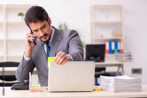 Young male employee working in the office