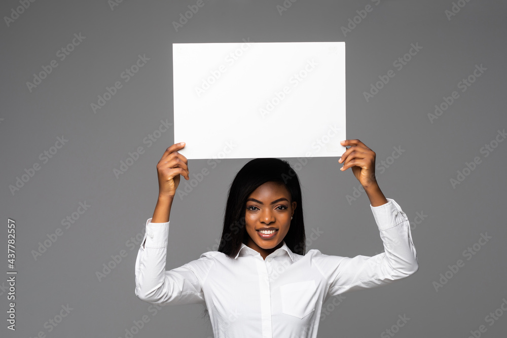 Happy African American business woman holding placard on white background Happy African American business woman holding placard on white background