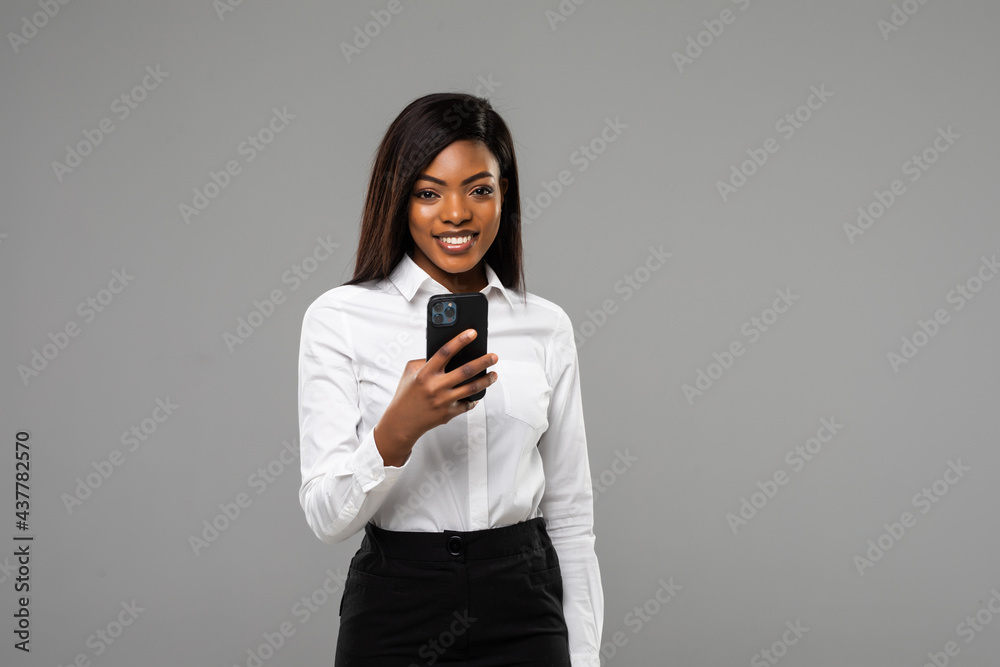 African business woman use smart phone isolated on gray background African business woman use smart phone isolated on gray background