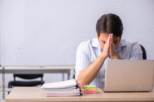 Young male teacher in front of whiteboard