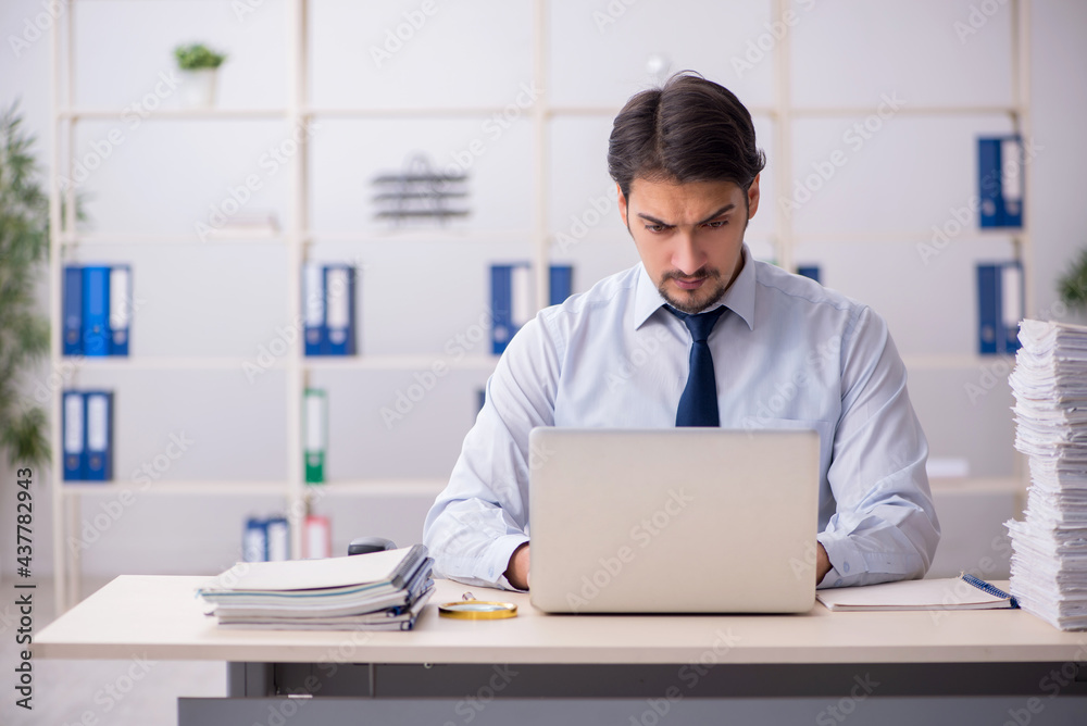 Young businessman employee unhappy with excessive work in the of Young businessman employee unhappy with excessive work in the of