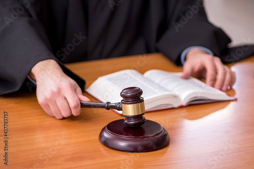 Young male judge working in the courtroom