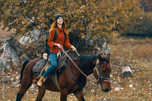 woman hiker riding horse mountains landscape travel adventure