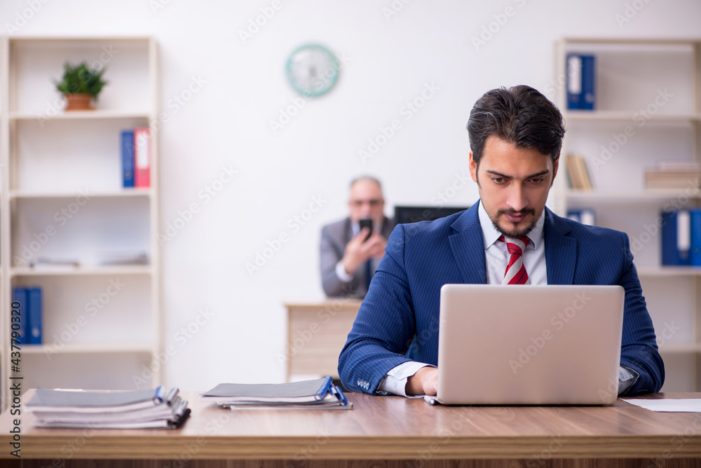 Two male employees working in the office Two male employees working in the office
