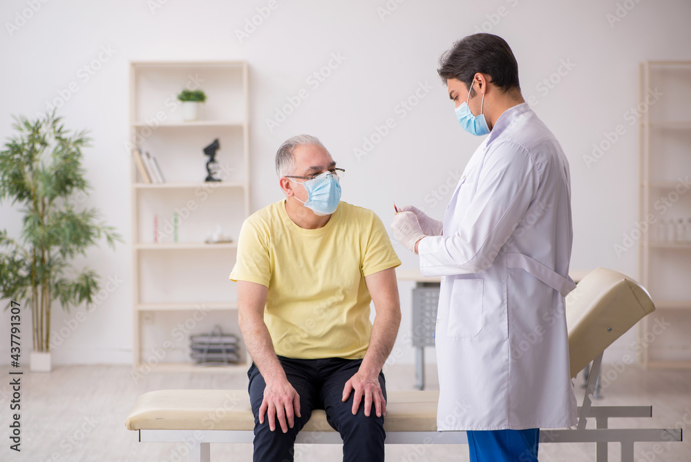 Old male patient visting young male doctor in vaccination concep Old male patient visting young male doctor in vaccination concep