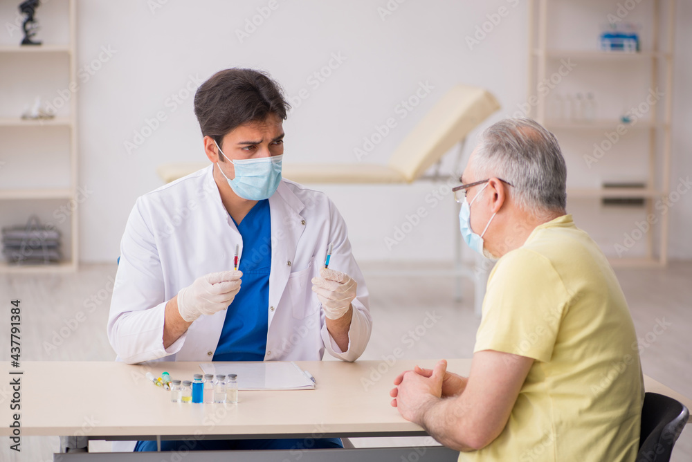 Fototapeta premium Old male patient visting young male doctor in vaccination concep