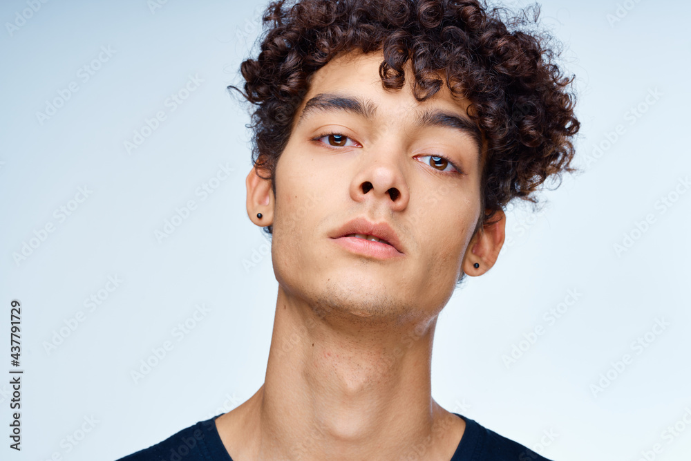 Obraz premium cute guy curly hair black t-shirt close-up model