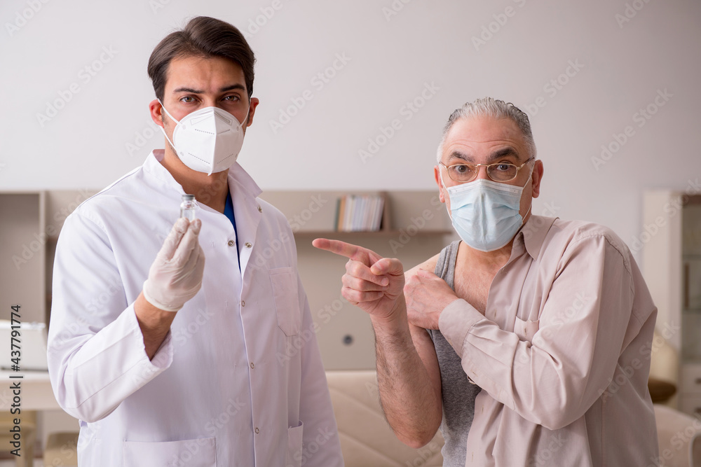 Young male doctor visiting old patient in vaccination concept Young male doctor visiting old patient in vaccination concept