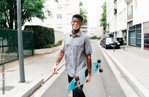 Man holding a skateboard