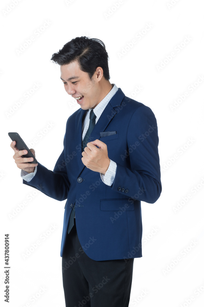 Young attractive asian business man wearing navy blue suit with white shirt and necktie checking on his mobile phone and celebrating on white background isolated Young attractive asian business man wearing navy blue suit with white shirt and necktie checking on his mobile phone and celebrating on white background isolated