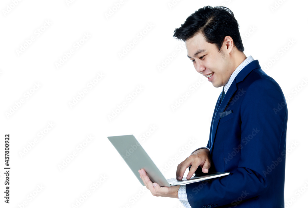 Young attractive asian business man wearing navy blue suit with white shirt and necktie holding and using his laptop on white background isolated