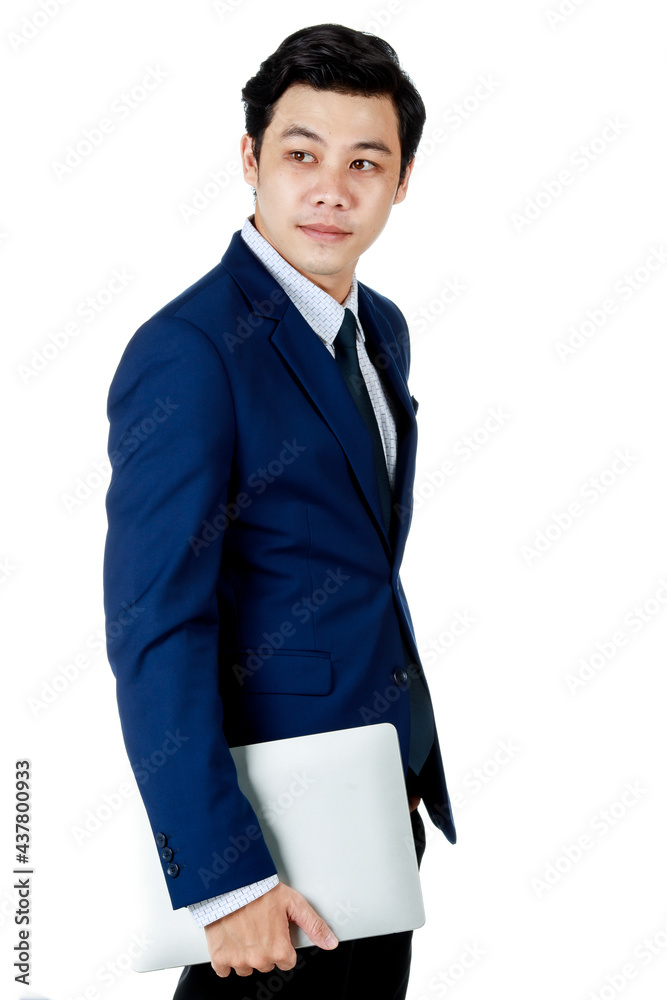 Young attractive asian business man wearing navy blue suit with white shirt and necktie turning side way holding laptop on one on white background isolated Young attractive asian business man wearing navy blue suit with white shirt and necktie turning side way holding laptop on one on white background isolated