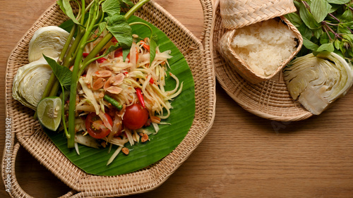 Somtum or papaya salad with vegetables and sticky rice, Thai traditional food