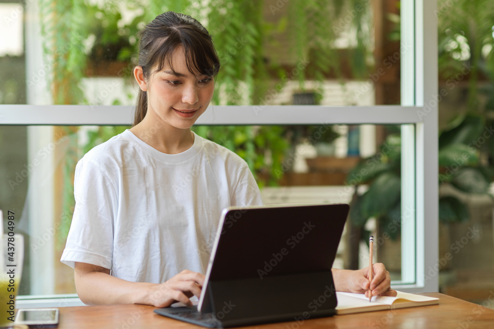 Portrait of female student doing homework with digital tablet and stationery in home garden Portrait of female student doing homework with digital tablet and stationery in home garden