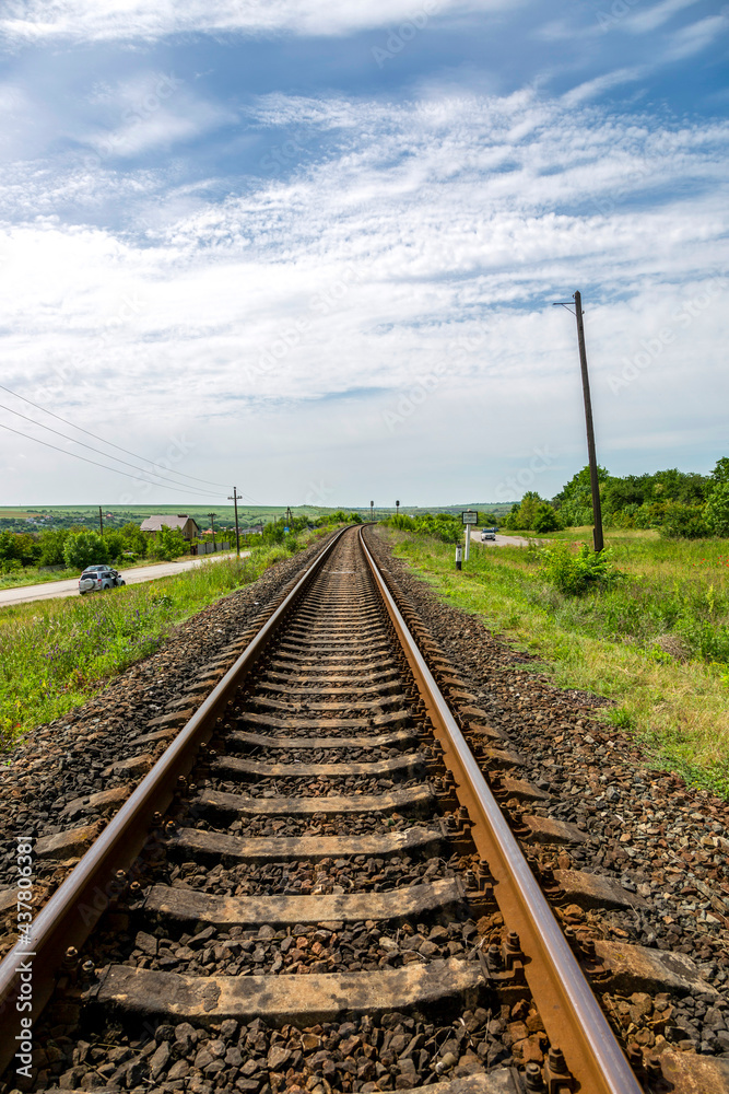 Summer landscape with railroad rails and road Summer landscape with railroad rails and road