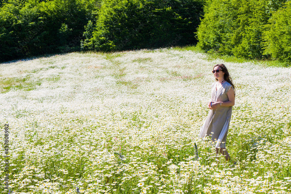 Women with dress in field of daisy flowers Women with dress in field of daisy flowers