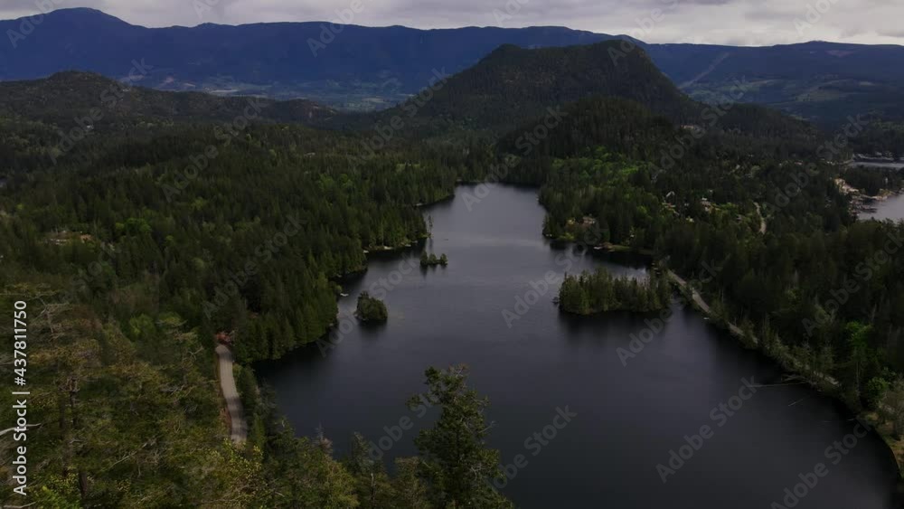 Reverse aerial drone shot of Hotel Lake in Pender Harbour, British Columbia. Reverse aerial drone shot of Hotel Lake in Pender Harbour, British Columbia.