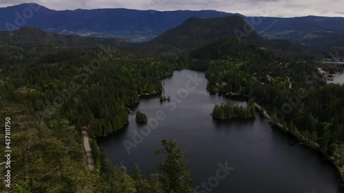 Reverse aerial drone shot of Hotel Lake in Pender Harbour, British Columbia. photo