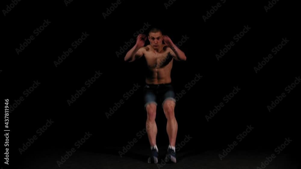 Young pumped man runs out of the dark and doing a flip in the arena Young pumped man runs out of the dark and doing a flip in the arena
