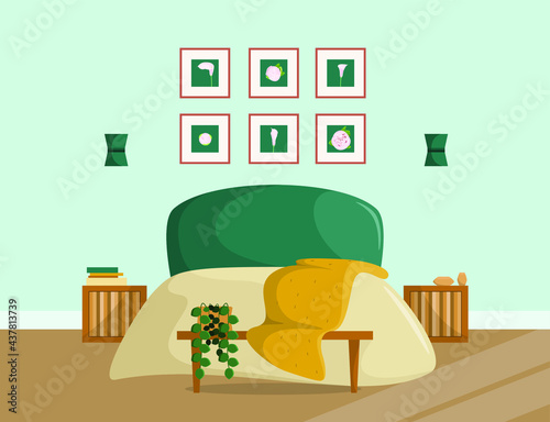 Modern bedroom design. A large bed with a blanket, paintings, bedside tables. Cozy house.